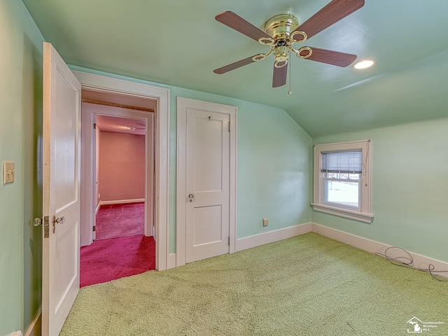 bonus room with vaulted ceiling, light colored carpet, and ceiling fan