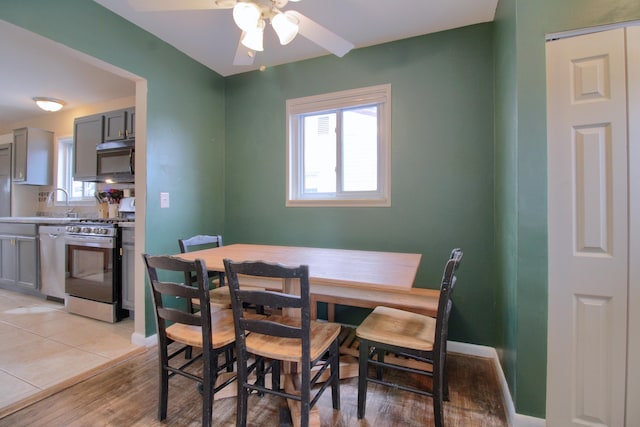 dining room with ceiling fan and light wood-type flooring