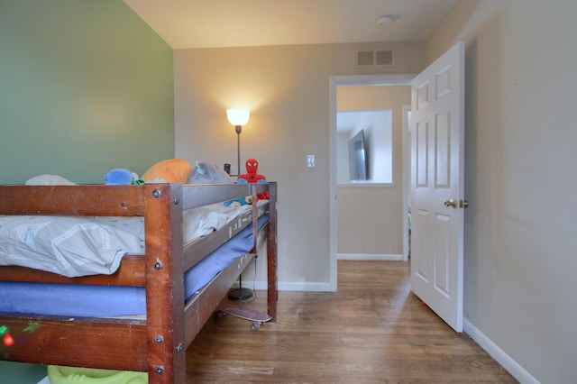 bedroom with hardwood / wood-style floors