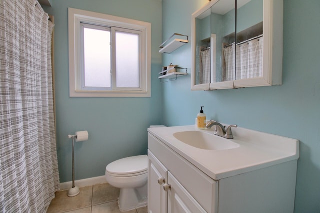 bathroom featuring toilet, vanity, and tile patterned flooring