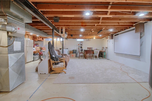 basement featuring washer / dryer and white fridge