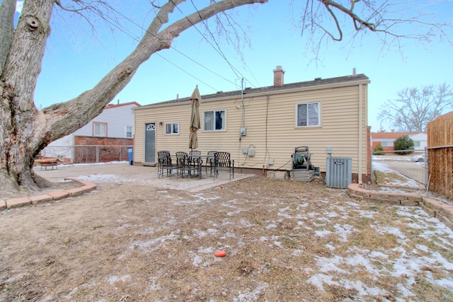 back of house featuring central AC unit