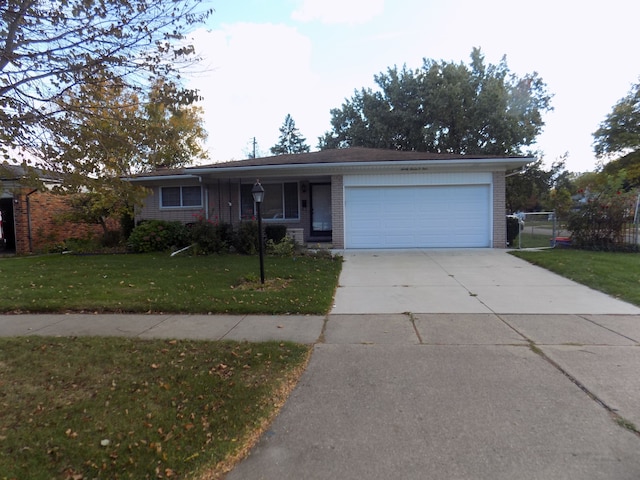 ranch-style home with a garage and a front lawn