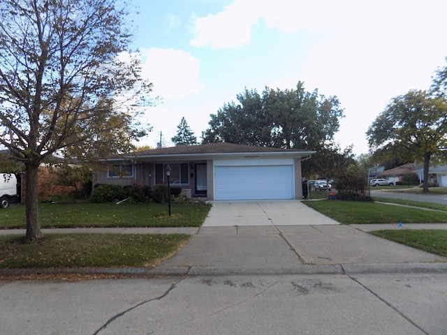 view of front of home with a garage and a front lawn