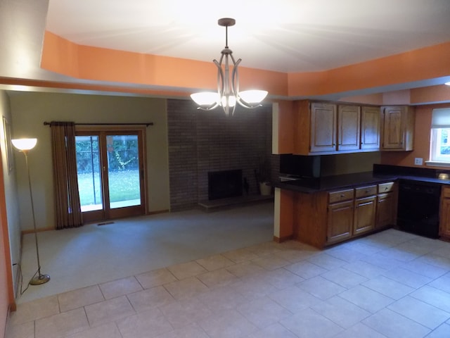 kitchen with a fireplace, dishwasher, a chandelier, hanging light fixtures, and light colored carpet