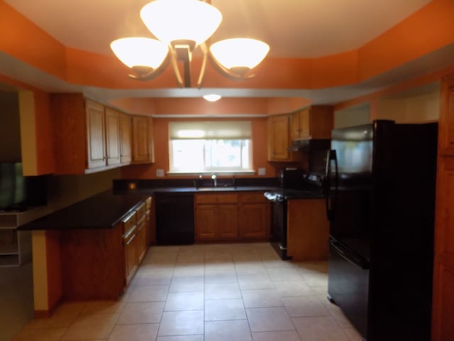 kitchen featuring light tile patterned flooring, sink, and black appliances