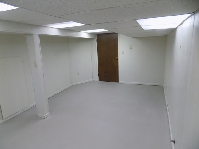 basement featuring a paneled ceiling