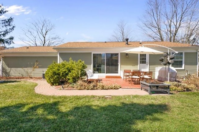 back of house with a yard and a patio