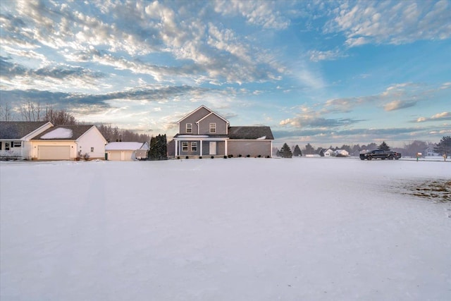 yard covered in snow featuring a garage