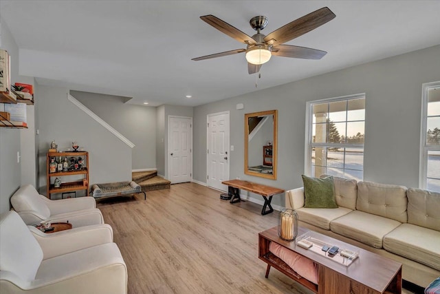 living room featuring ceiling fan and light hardwood / wood-style flooring