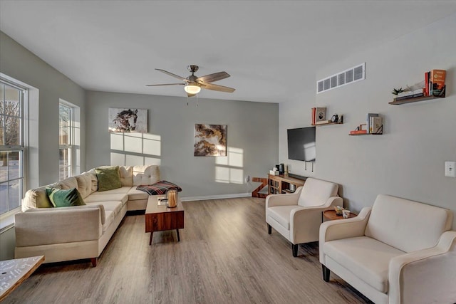 living room with hardwood / wood-style floors and ceiling fan