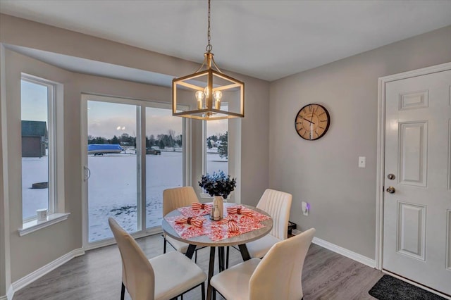 dining space featuring a chandelier and light hardwood / wood-style flooring