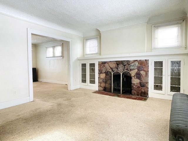 unfurnished living room with carpet, a textured ceiling, and a fireplace