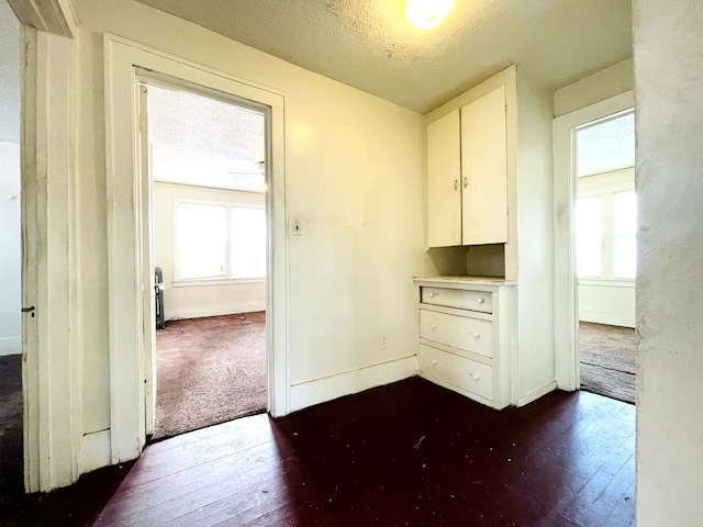 interior space with dark hardwood / wood-style floors and a textured ceiling