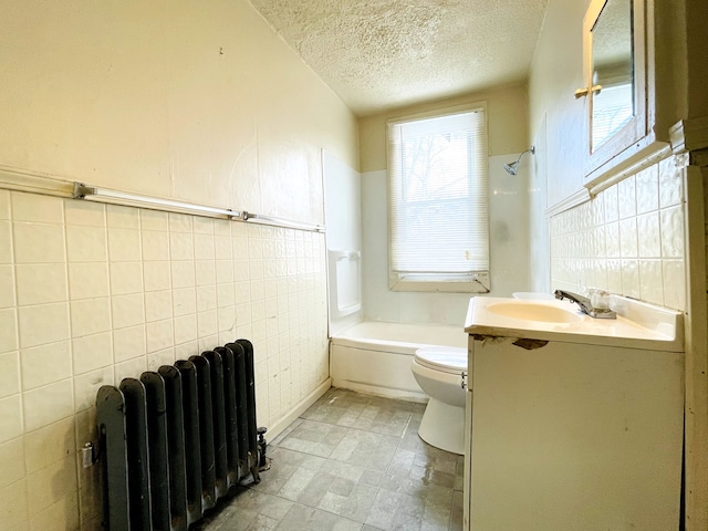 full bathroom featuring tile walls, vanity, radiator heating unit, and toilet