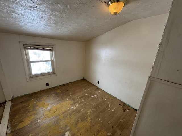 bonus room featuring a textured ceiling and vaulted ceiling