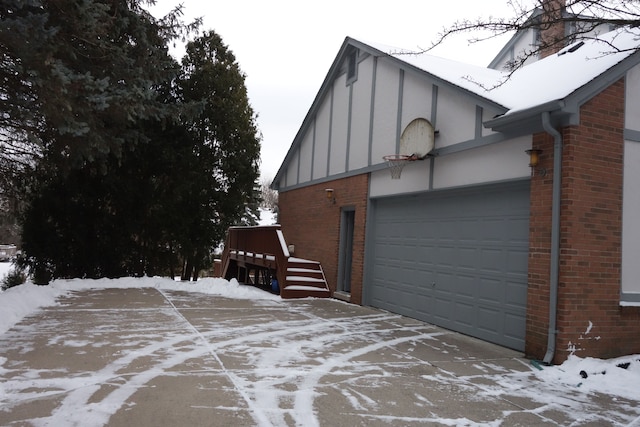 view of snow covered exterior featuring a garage