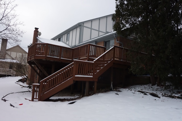 snow covered property featuring a wooden deck