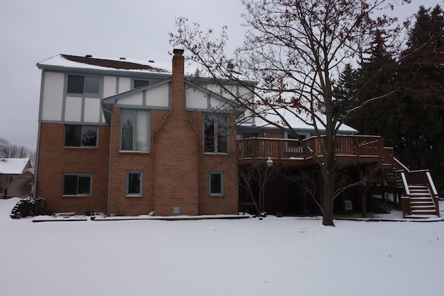 snow covered property with a deck