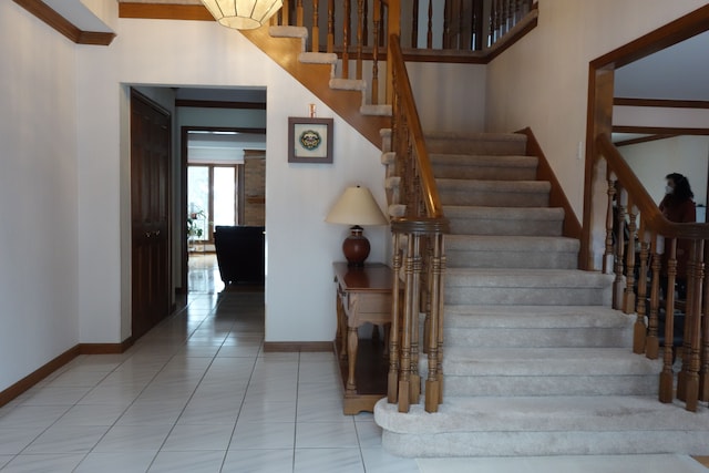 stairway with tile patterned flooring