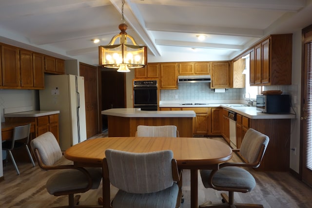 kitchen with sink, vaulted ceiling with beams, tasteful backsplash, hanging light fixtures, and white appliances