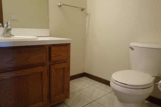 bathroom featuring vanity, tile patterned floors, and toilet