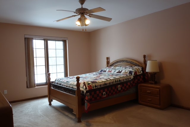 carpeted bedroom featuring multiple windows and ceiling fan