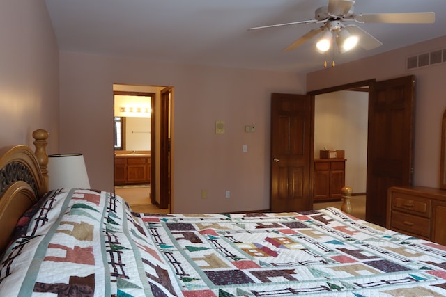 bedroom featuring sink, ensuite bath, and ceiling fan