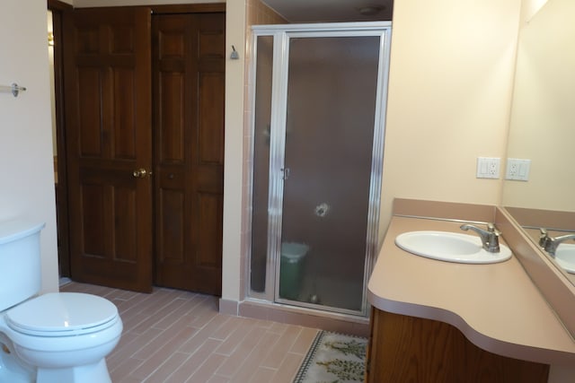 bathroom featuring vanity, toilet, and walk in shower