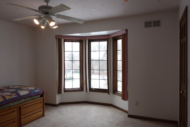 bedroom with light colored carpet and ceiling fan