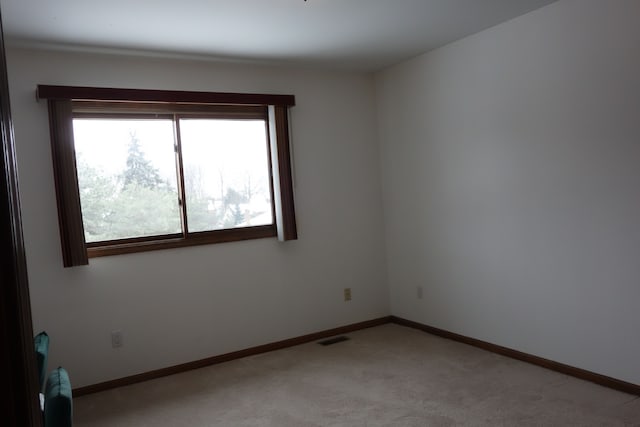 unfurnished room featuring light colored carpet