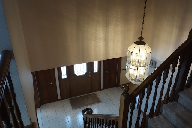 tiled entrance foyer featuring a chandelier