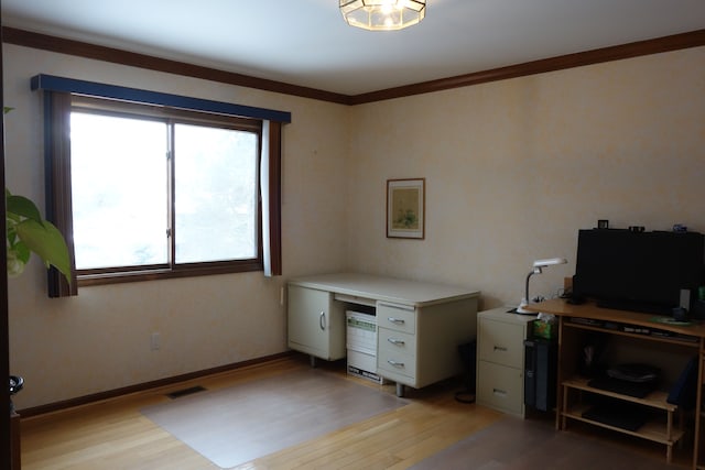 office space with ornamental molding and light hardwood / wood-style floors