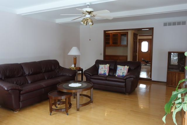 living room featuring light hardwood / wood-style flooring and ceiling fan