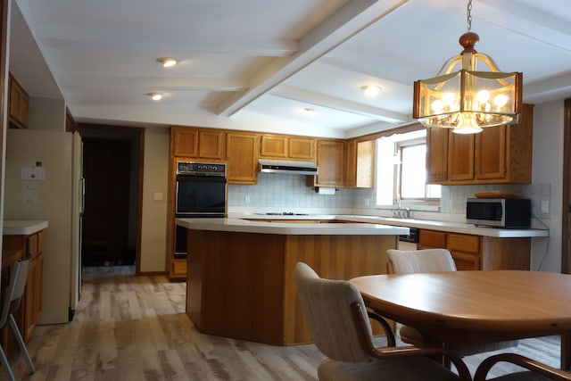 kitchen featuring double oven, hanging light fixtures, backsplash, white refrigerator, and lofted ceiling with beams