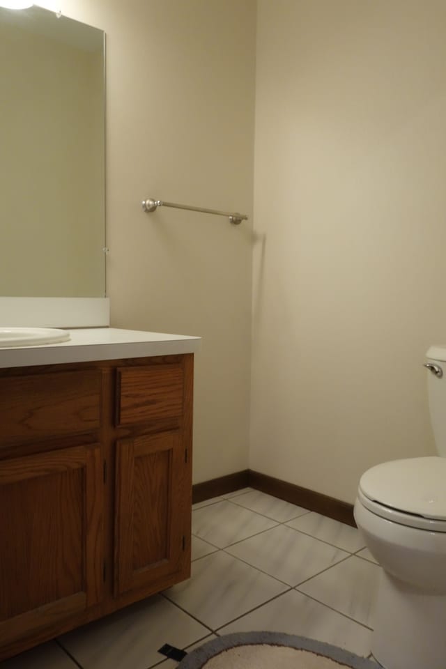 bathroom featuring tile patterned flooring, vanity, and toilet