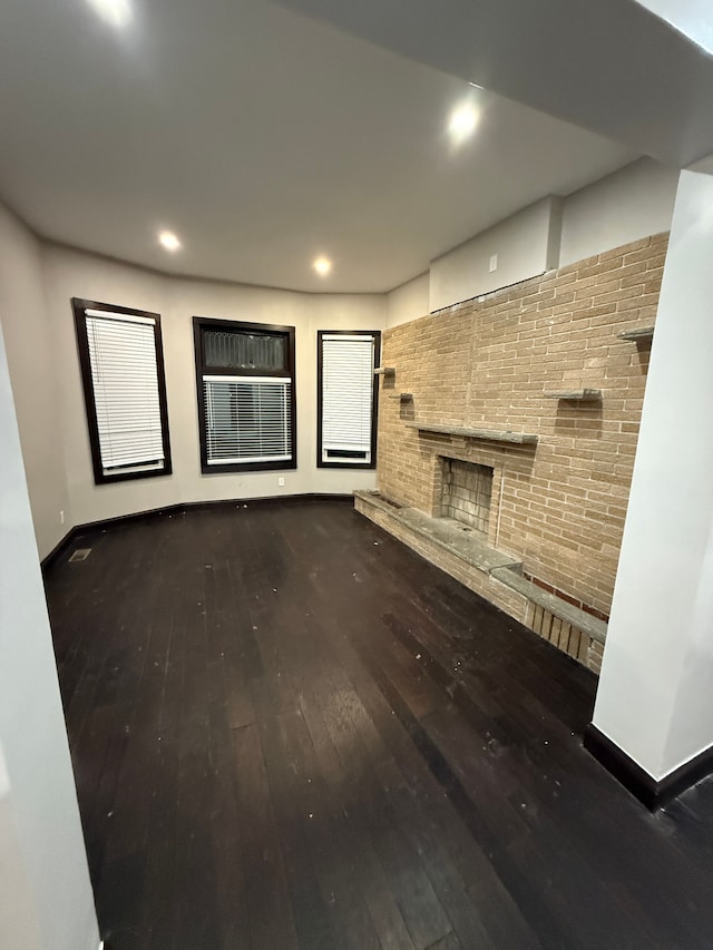 unfurnished living room with hardwood / wood-style floors and a fireplace