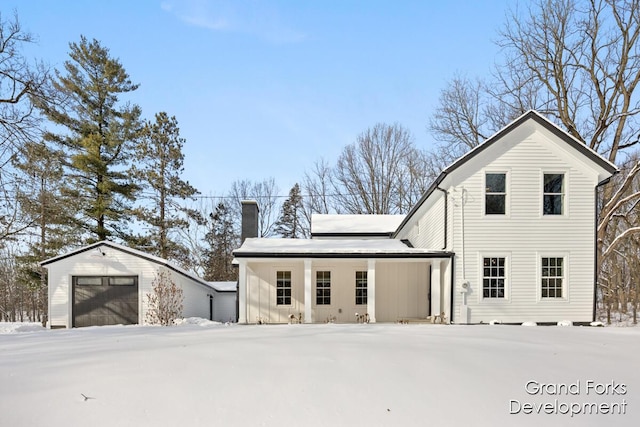 exterior space featuring a garage and an outdoor structure