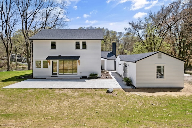101 Carl Dr NE, Ada, MI 49301 - back of house with a patio, a lawn, and a shingled roof