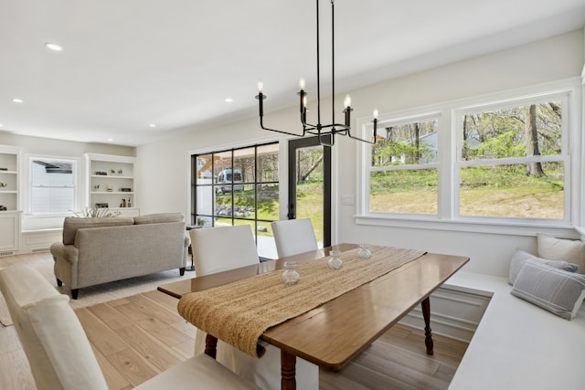 101 Carl Dr NE, Ada, MI 49301 - dining area featuring light wood-type flooring, a chandelier, and recessed lighting
