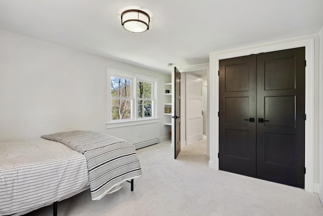101 Carl Dr NE, Ada, MI 49301 - bedroom with a baseboard heating unit, light carpet, and a closet