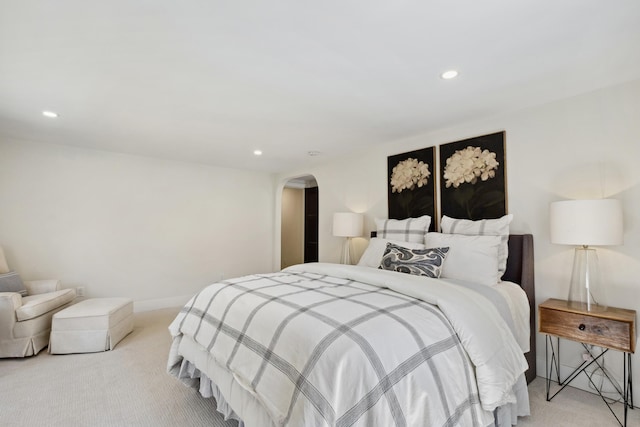 101 Carl Dr NE, Ada, MI 49301 - bedroom with light colored carpet, arched walkways, recessed lighting, and baseboards