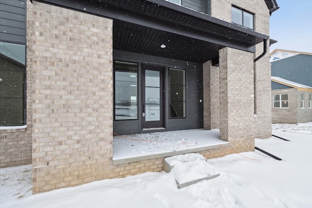 view of snow covered property entrance