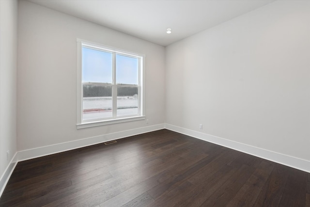 unfurnished room with dark hardwood / wood-style floors