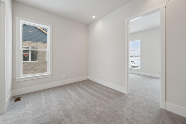 empty room with light colored carpet