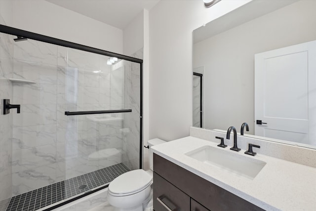 bathroom featuring vanity, toilet, and walk in shower