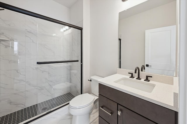 bathroom with vanity, an enclosed shower, and toilet