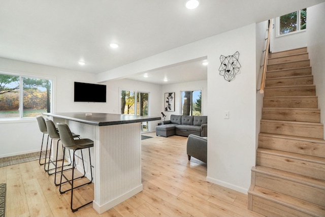 kitchen with light hardwood / wood-style flooring and a breakfast bar area