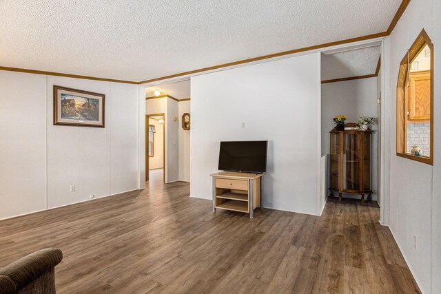 unfurnished living room with crown molding, dark hardwood / wood-style floors, vaulted ceiling, and a textured ceiling