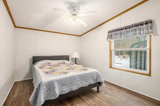 bedroom with crown molding, ceiling fan, wood-type flooring, and a textured ceiling
